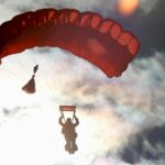 person skydiving over mountains