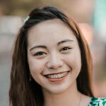 person smiling outdoors